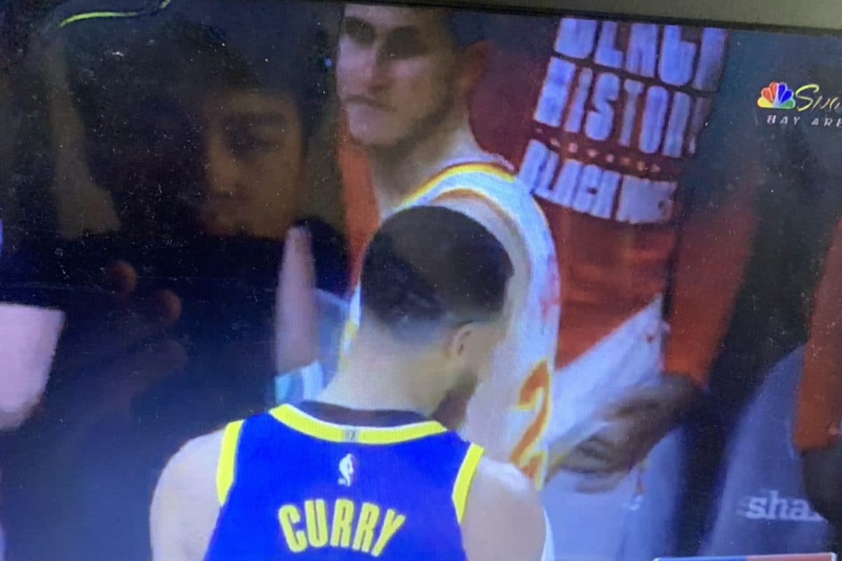 Watching Stephen Curry play for the Warriors on a laptop