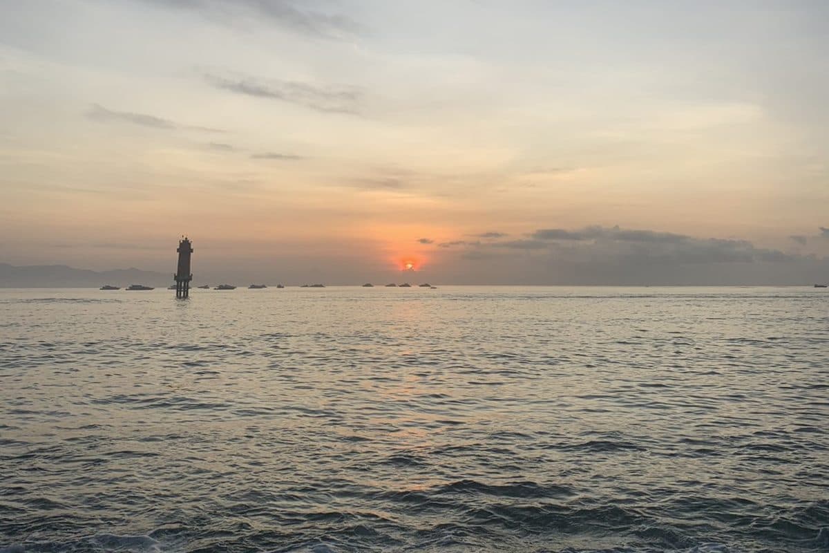 The sun setting over a calm sea
